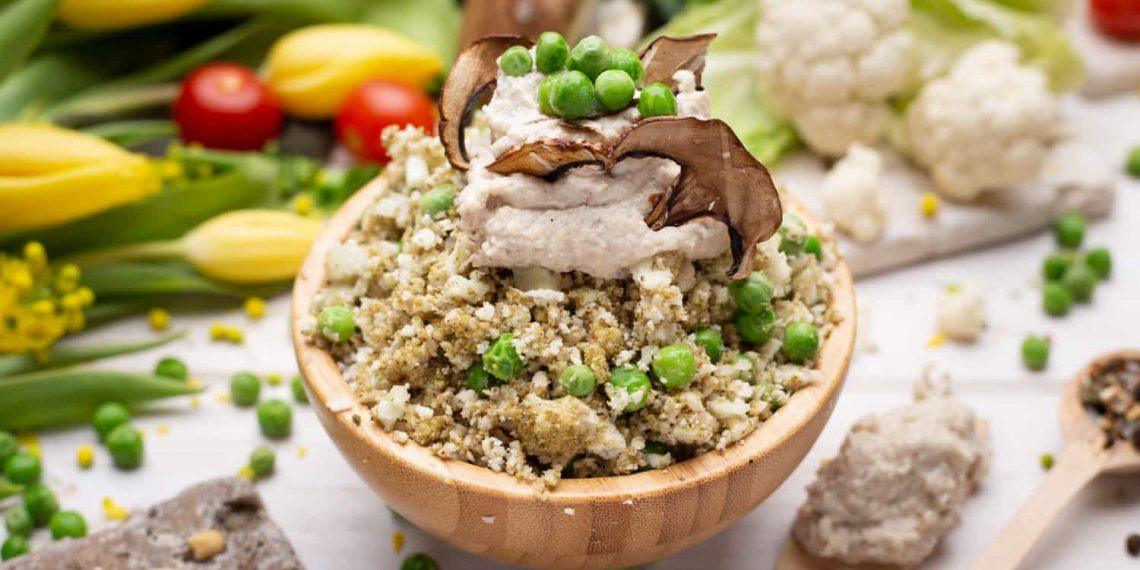 Bowl of vibrant vegetables with grains and herbs – holistic eating recipes