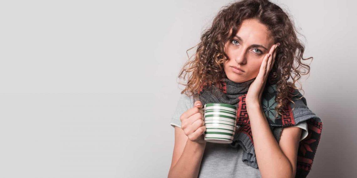Tired woman holding coffee cup suffering from adrenal fatigue mistakes