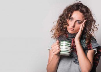 Tired woman holding coffee cup suffering from adrenal fatigue mistakes