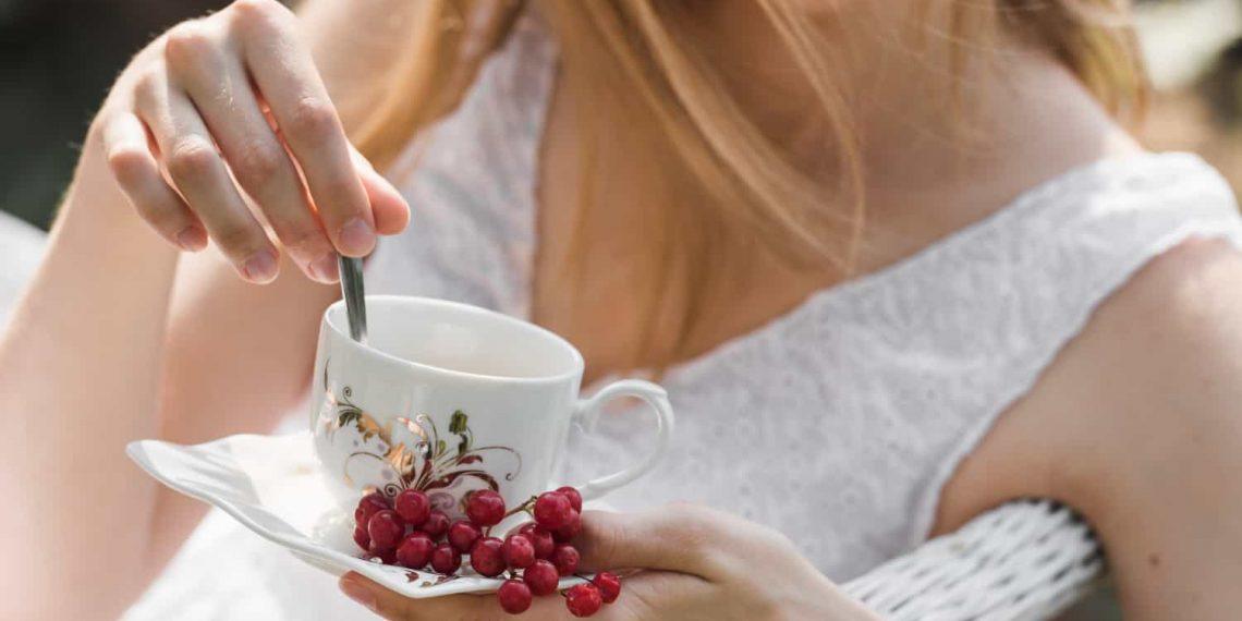 Woman holding herbal tea, highlighting natural remedies for UTIs