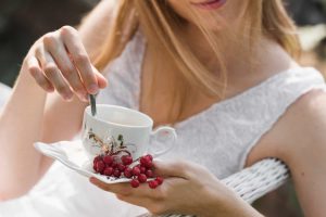 Woman holding herbal tea, highlighting natural remedies for UTIs
