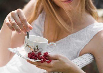 Woman holding herbal tea, highlighting natural remedies for UTIs