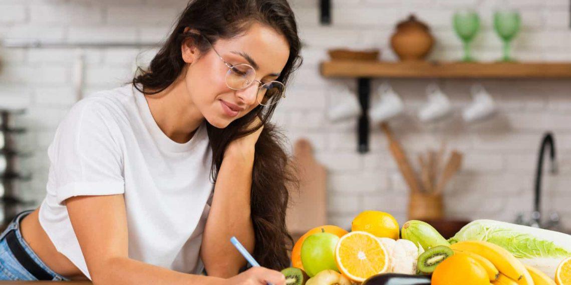 Woman reviewing a weight loss diet plan checklist highlighting common weight loss diet plan mistakes