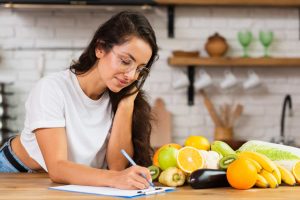 Woman reviewing a weight loss diet plan checklist highlighting common weight loss diet plan mistakes