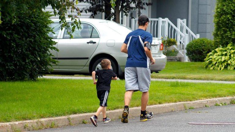 man and kid jogging outdoors enjoying healthy living benefits
