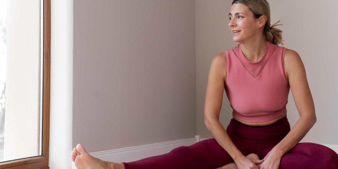 Woman doing yoga to reset metabolism after 40
