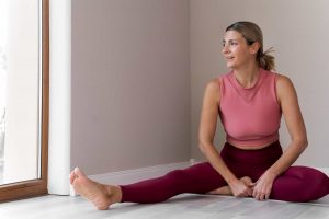 Woman doing yoga to reset metabolism after 40
