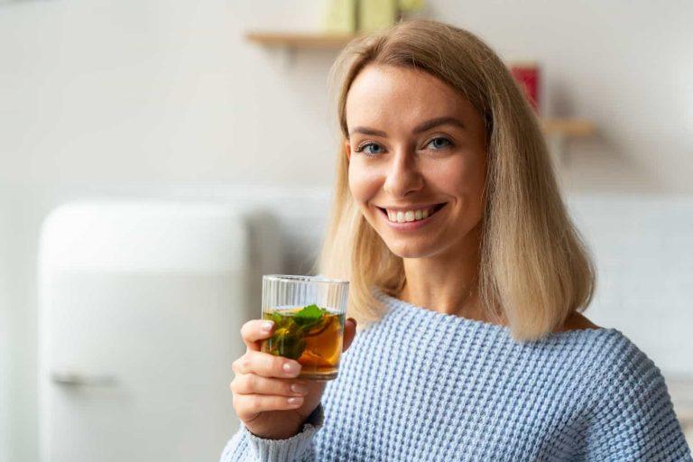 Woman enjoying herbal tea to lose weight drinking tea