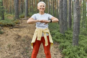 Woman walking through nature trail promoting a healthy lifestyle at any age