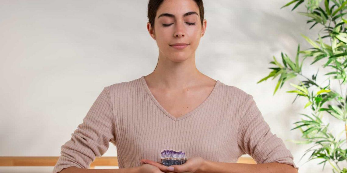 person meditating with calm expression using natural remedies for tinnitus