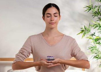 person meditating with calm expression using natural remedies for tinnitus