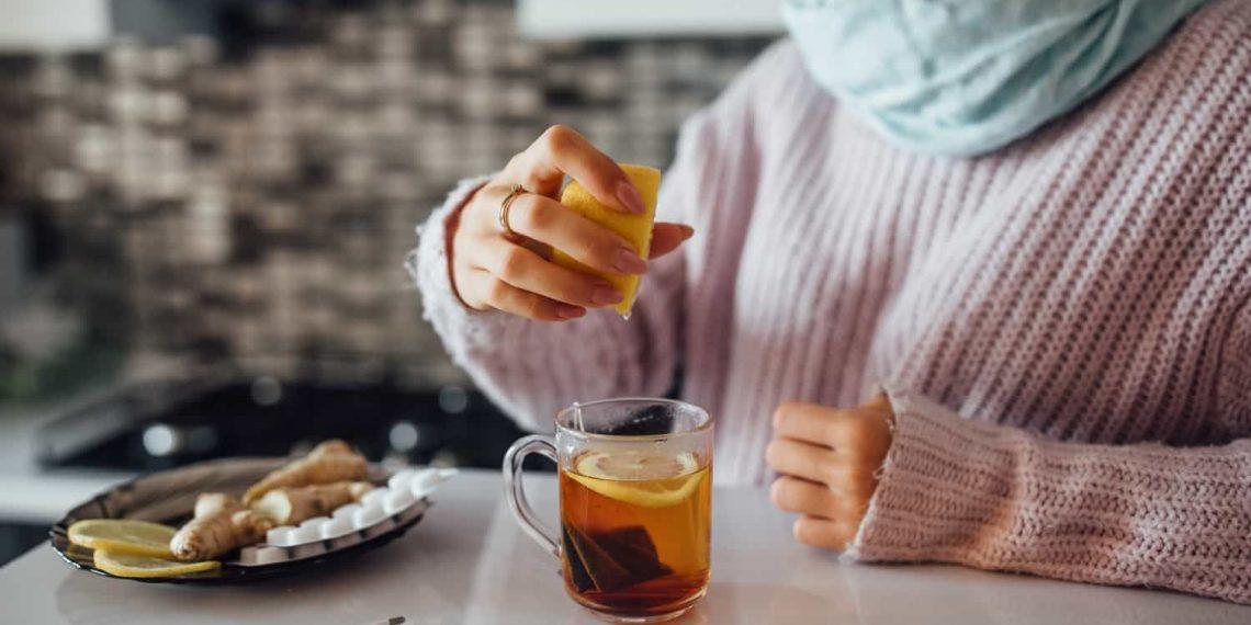 A woman drinking herbal tea to boost immunity naturally during flu season