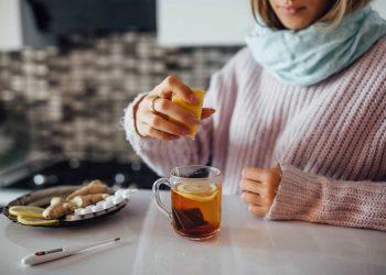 A woman drinking herbal tea to boost immunity naturally during flu season