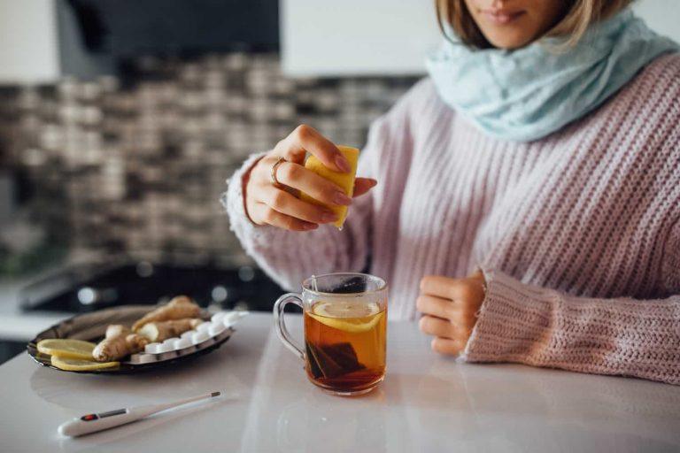 A woman drinking herbal tea to boost immunity naturally during flu season