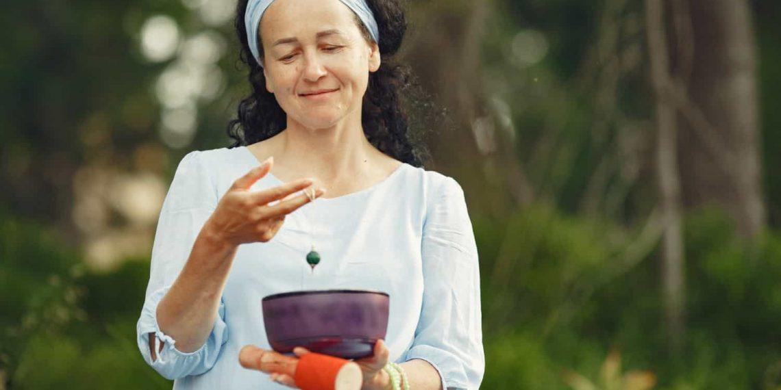 Woman practicing longevity as a lifestyle with meditation and healthy food