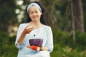Woman practicing longevity as a lifestyle with meditation and healthy food