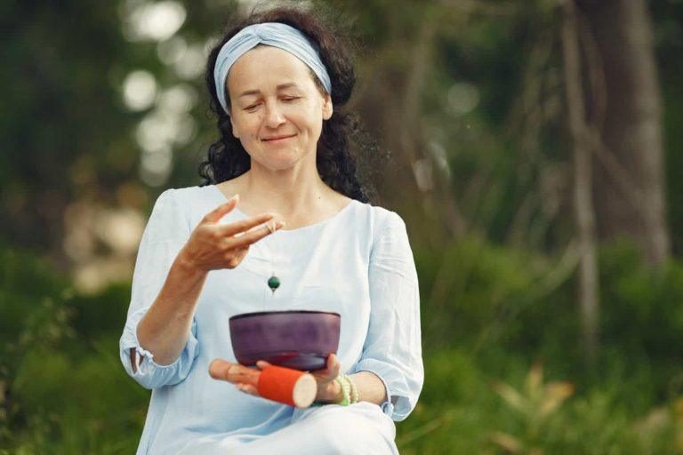 Woman practicing longevity as a lifestyle with meditation and healthy food