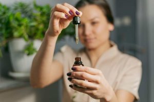 Woman using essential oils for tension headache relief