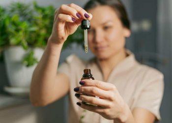 Woman using essential oils for tension headache relief