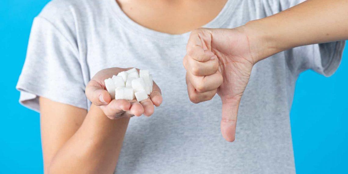 woman smiling after cutting sugar cancer risk