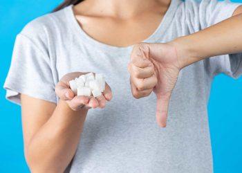 woman smiling after cutting sugar cancer risk