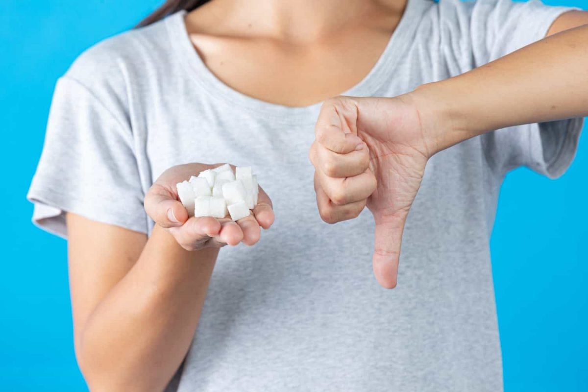 woman smiling after cutting sugar cancer risk
