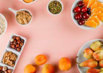 A colorful assortment of healthy snacks including fresh fruits, nuts, and vegetables representing healthy snacks for weight loss