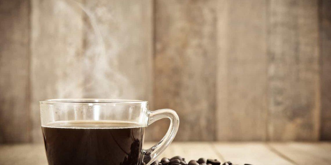 Close-up image of steaming coffee mug showing caffeine in a cup of coffee