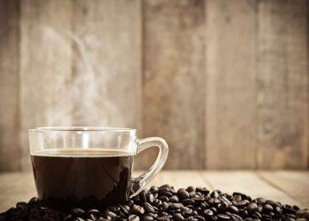 Close-up image of steaming coffee mug showing caffeine in a cup of coffee