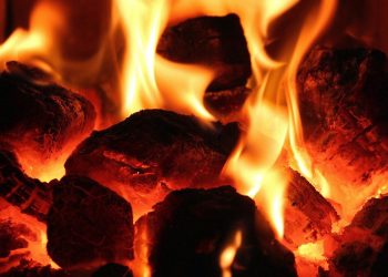 Burning hot coals with bright orange flames.