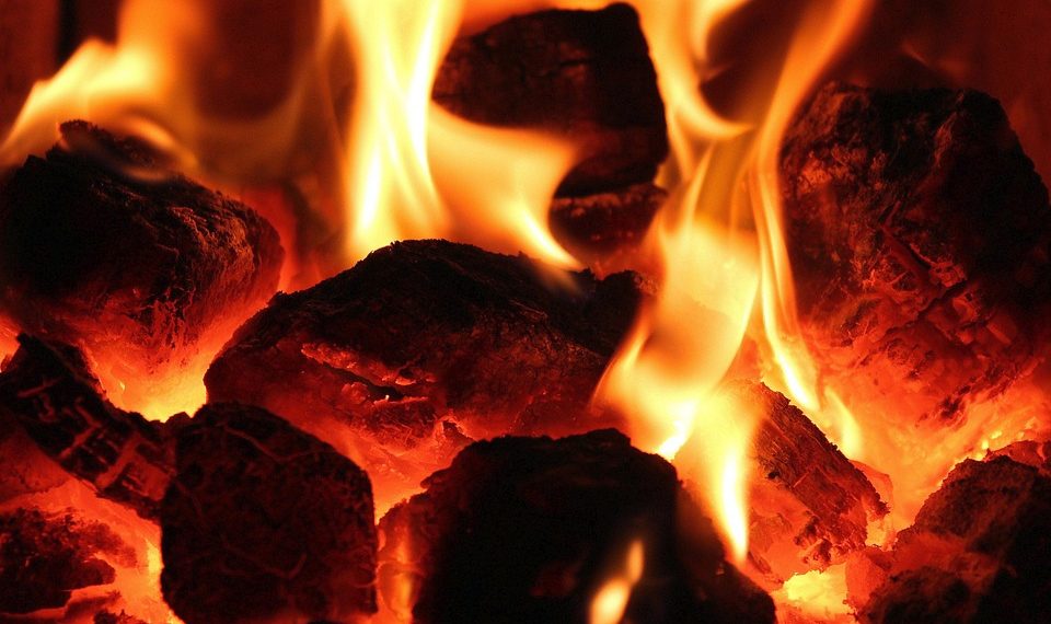 Burning hot coals with bright orange flames.