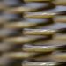 Golden metal coil with blurred background.