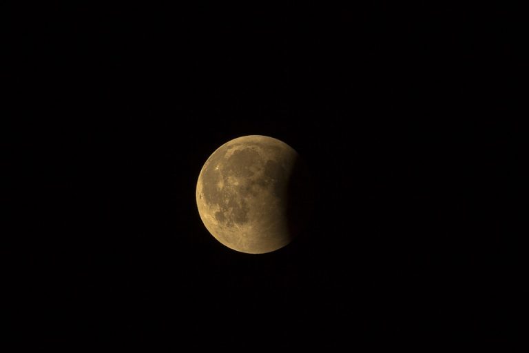 Lunar eclipse with Earth's shadow covering part of the moon.