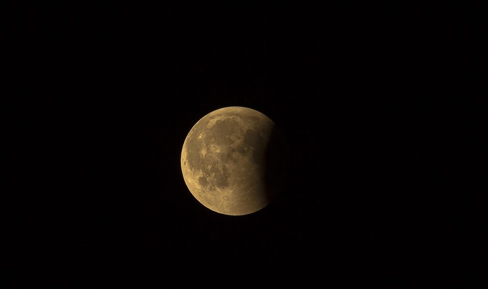 Lunar eclipse with Earth's shadow covering part of the moon.
