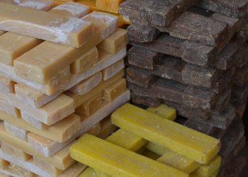 Stacked raw soap bars in various colors.
