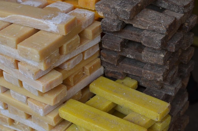 Stacked raw soap bars in various colors.