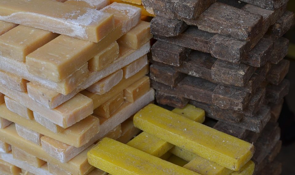 Stacked raw soap bars in various colors.