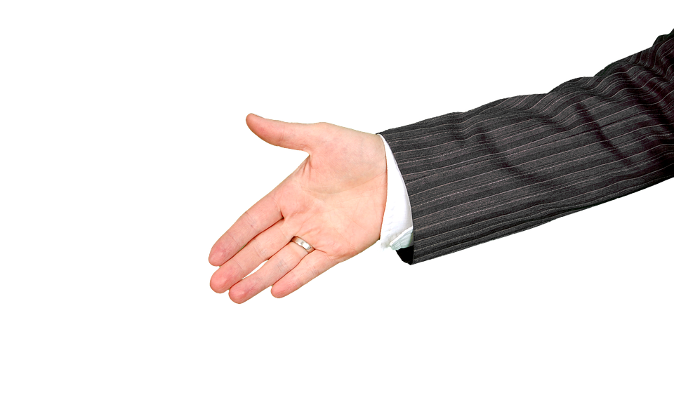 Hand extended for a handshake in business attire