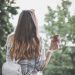 Woman with long hair enjoying outdoor coffee.