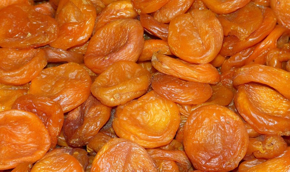 Dried apricots stacked closely together.