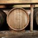 Wooden wine barrels in a cellar.
