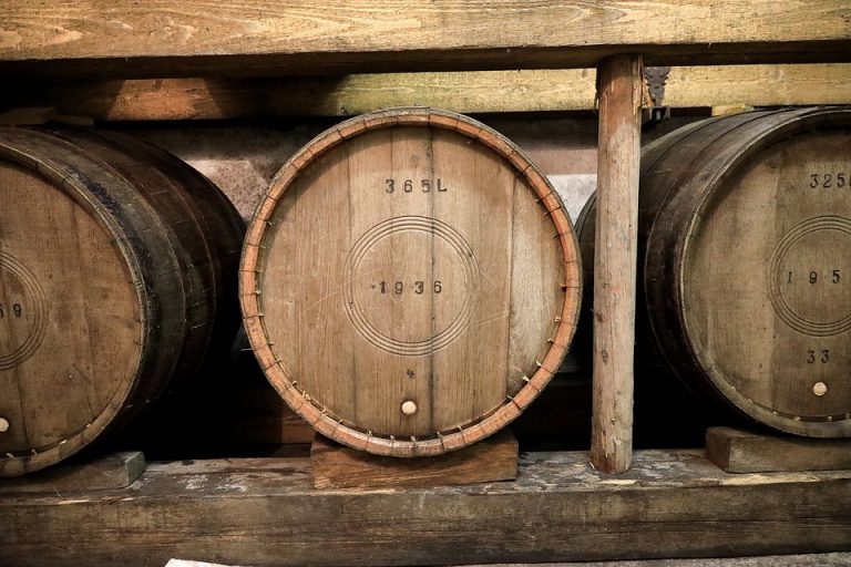 Wooden wine barrels in a cellar.