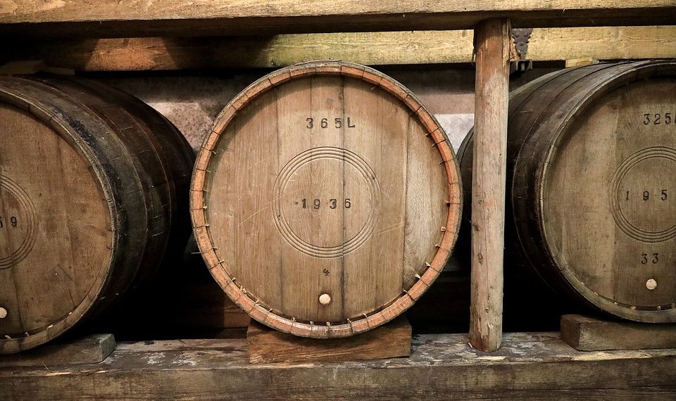 Wooden wine barrels in a cellar.