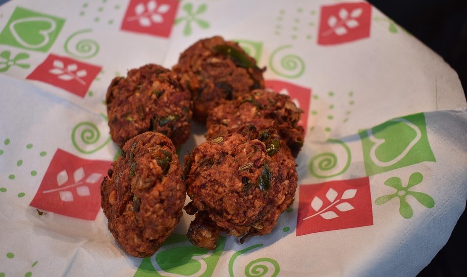 Pakoras served on decorative paper.