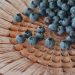 Blueberries scattered on a decorative plate.