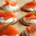 Fresh salmon on crackers with cream cheese and chives.