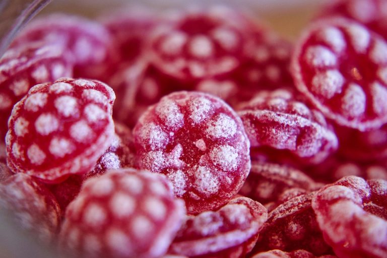 Red raspberry candies with sugar coating.