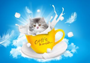 Cute kitten peeking out of a yellow coffee mug with splashes of milk.