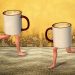 Twcoffee mugs with human legs running on a textured floor.