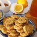 Oatmeal cookies on a plate with lemons and honey ingredients.